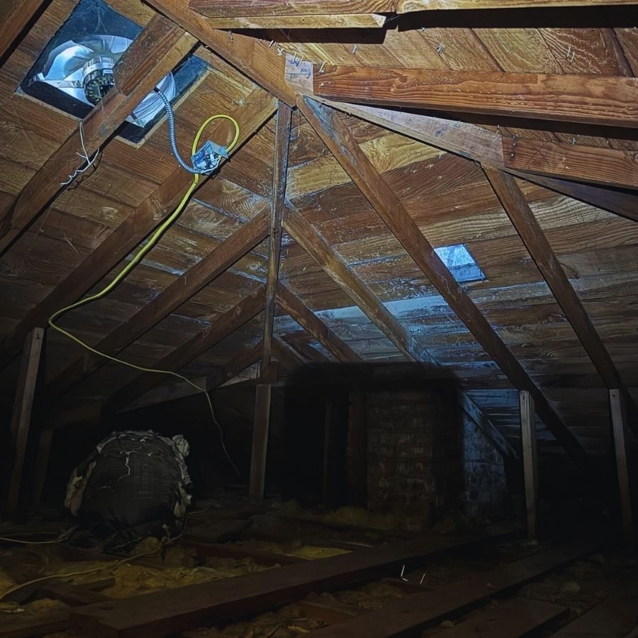 inspecting an attic during a roof damage inspection looking for water damage or intrusion