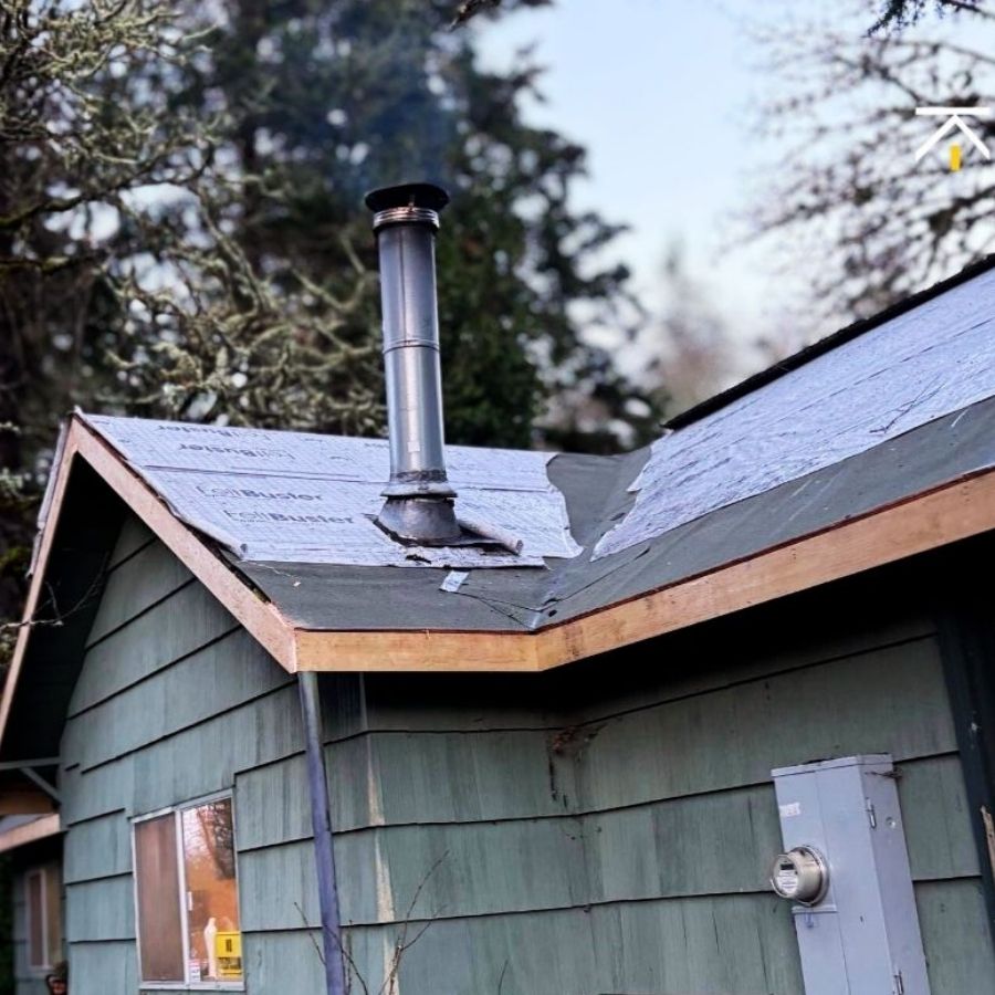 a picture of a roof mid-installation with underlayment showing before new shingles are added